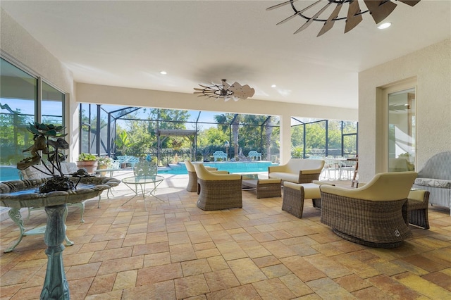 sunroom with ceiling fan and a pool