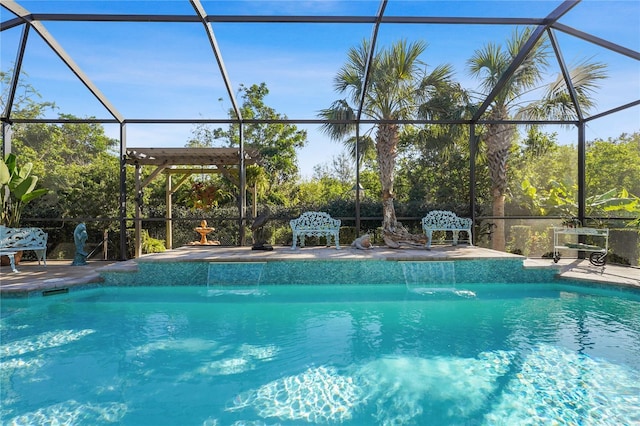 view of pool featuring glass enclosure, pool water feature, and a patio