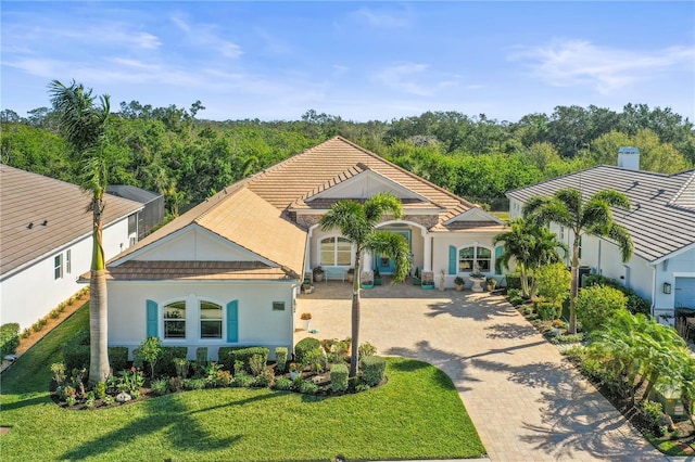 mediterranean / spanish-style home with a front yard