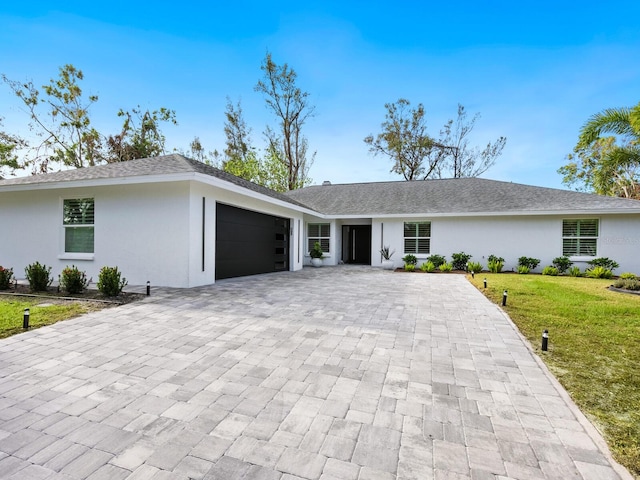 ranch-style house with a front lawn and a garage