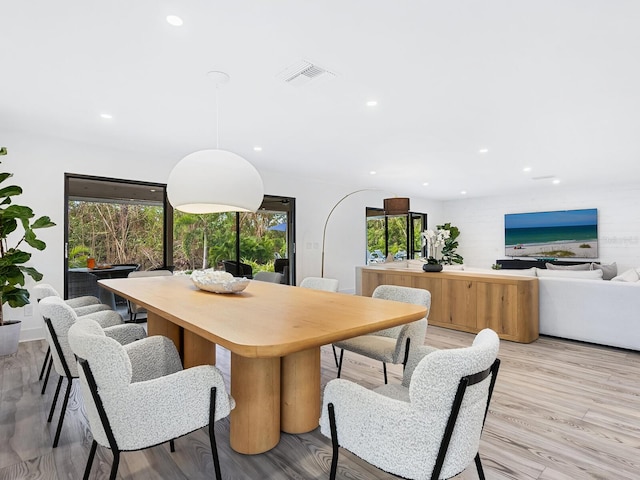 dining space featuring light wood-type flooring