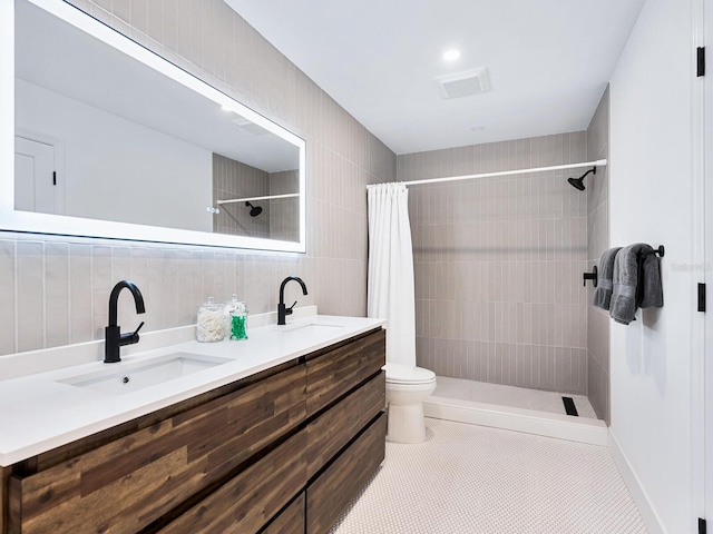 bathroom featuring vanity, a shower with curtain, tile patterned flooring, decorative backsplash, and tile walls