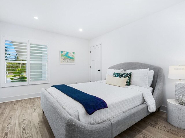 bedroom with hardwood / wood-style flooring