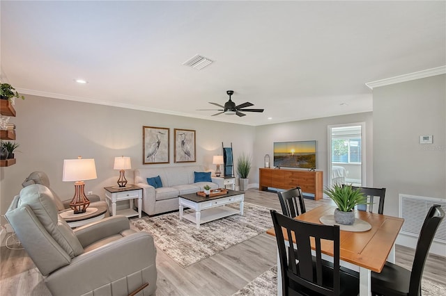 living room with light hardwood / wood-style flooring, ceiling fan, and crown molding