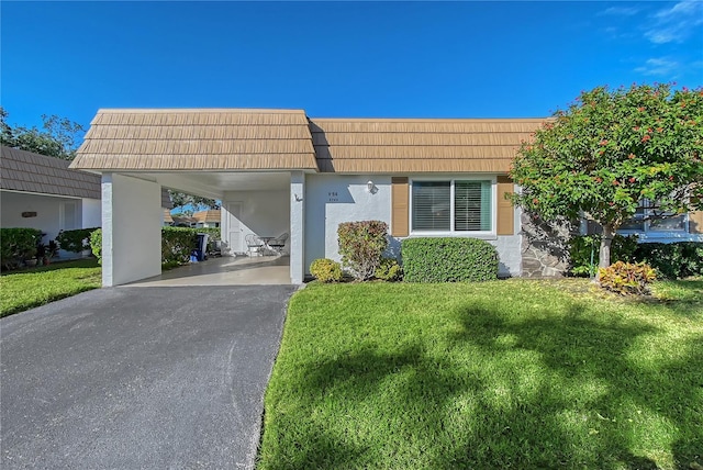 view of front of house featuring a front lawn and a carport