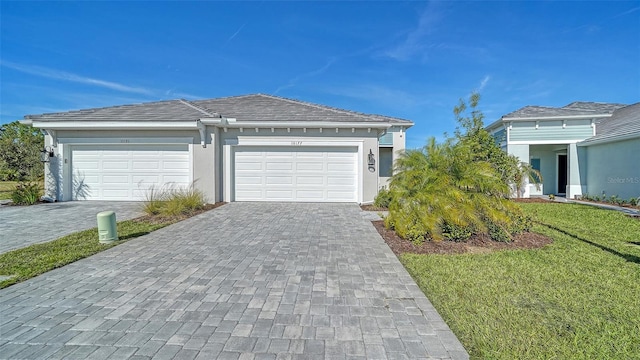 view of front facade featuring a garage and a front lawn