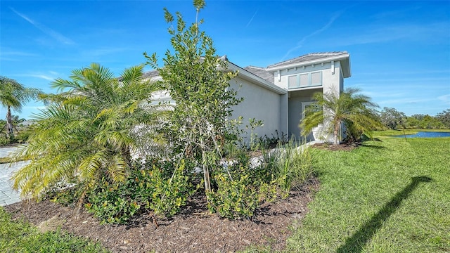 view of side of home featuring a lawn