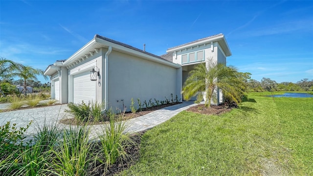 view of side of home featuring a lawn and a garage