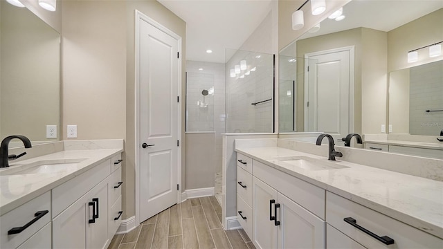 bathroom with vanity and tiled shower