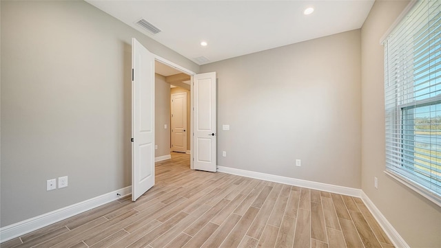 spare room featuring light hardwood / wood-style flooring