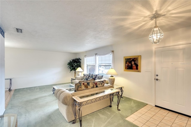 carpeted living room with a textured ceiling and a chandelier