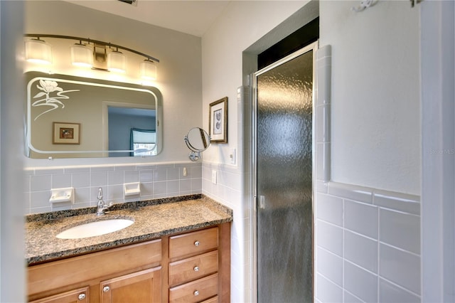 bathroom featuring vanity and an enclosed shower