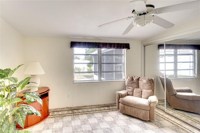 living area with carpet flooring and ceiling fan