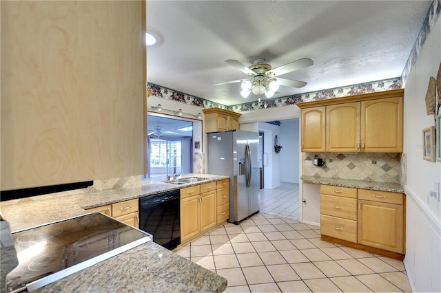 kitchen with light stone countertops, ceiling fan, decorative backsplash, light tile patterned floors, and black appliances