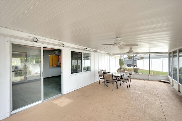 sunroom / solarium featuring ceiling fan