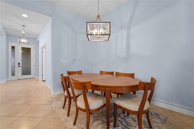 tiled dining area with a chandelier