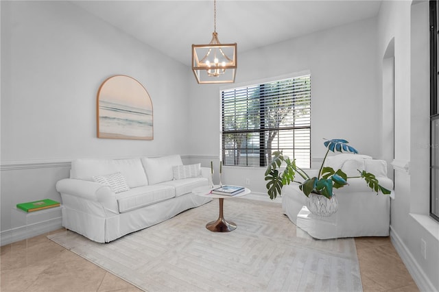 tiled living room with an inviting chandelier