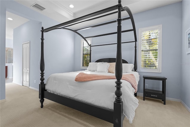 bedroom with light carpet, a closet, and crown molding