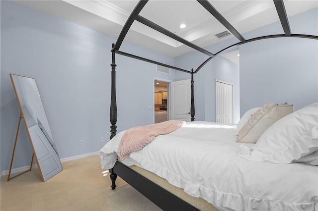 bedroom featuring washer / clothes dryer, a closet, and light colored carpet