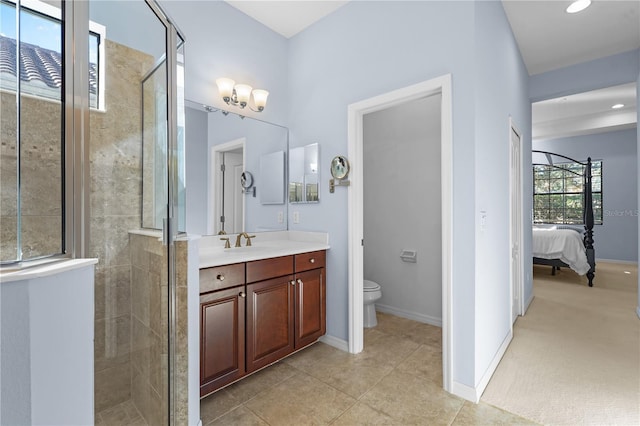 bathroom featuring tile patterned floors, vanity, a shower with shower door, and toilet