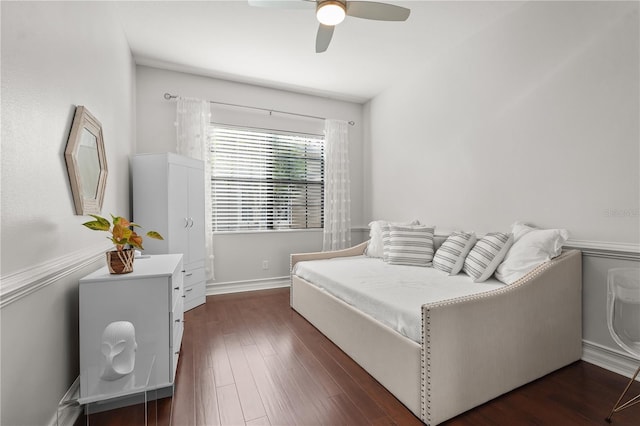 bedroom with ceiling fan and dark hardwood / wood-style flooring