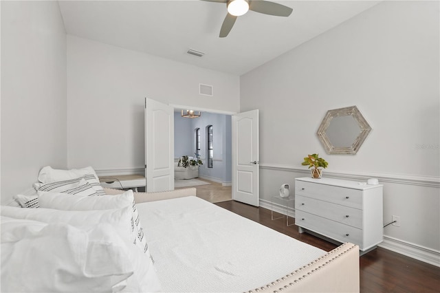 bedroom with ceiling fan and dark wood-type flooring