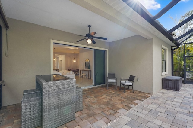 view of patio / terrace with ceiling fan and a lanai