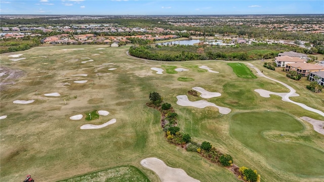 drone / aerial view with a water view and golf course view