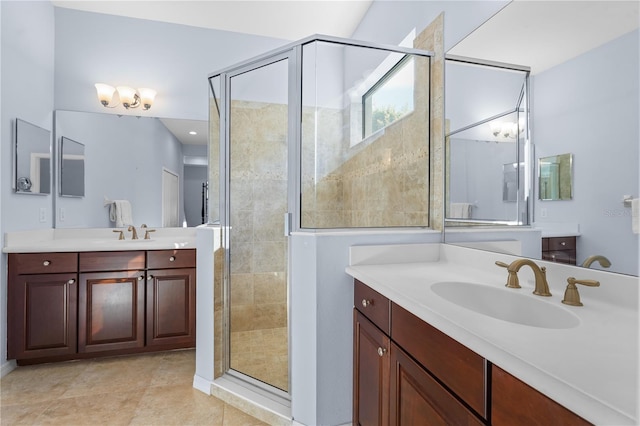 full bath featuring a stall shower, two vanities, a sink, and tile patterned floors