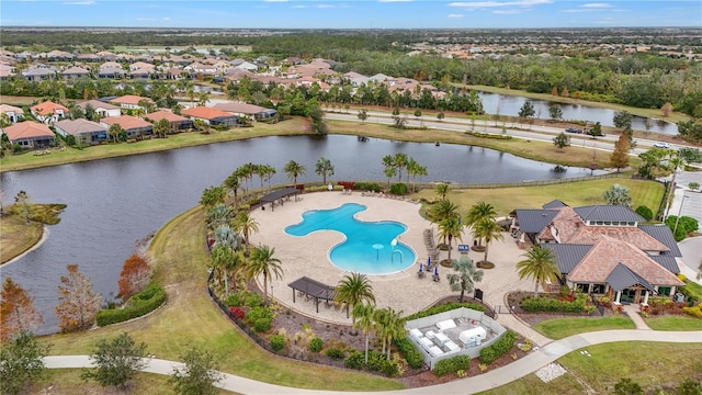 drone / aerial view featuring a water view and a residential view