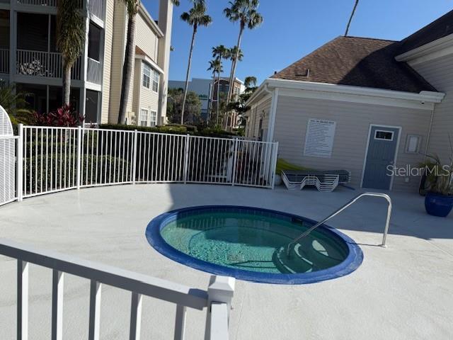 view of pool featuring a community hot tub and a patio area