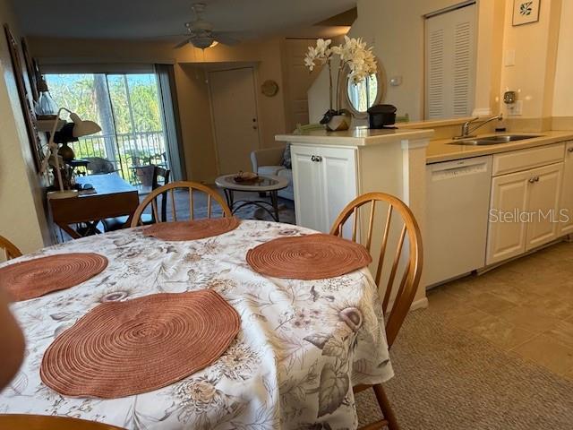 dining room featuring ceiling fan and sink