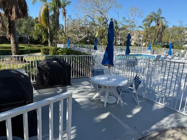 view of patio / terrace featuring area for grilling and a community pool