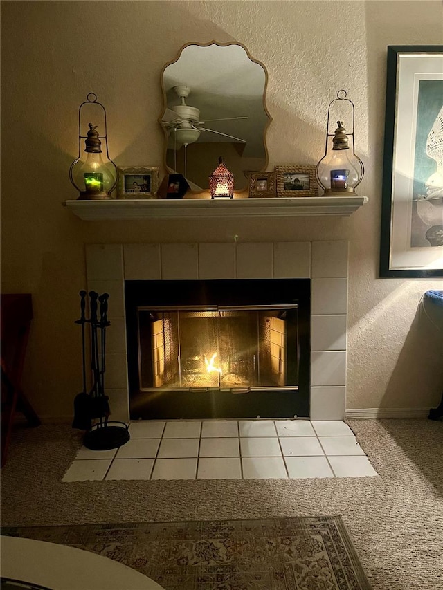 details featuring ceiling fan, a fireplace, and carpet