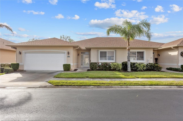 ranch-style house with a garage and a front yard