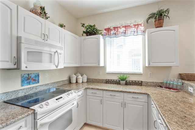 kitchen featuring white cabinets and white appliances