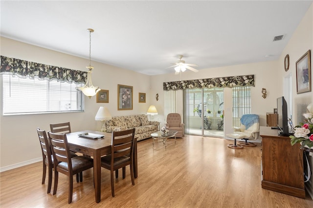 dining space with light hardwood / wood-style flooring, plenty of natural light, and ceiling fan