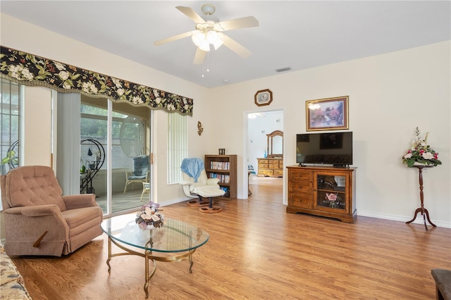 living room with ceiling fan and light hardwood / wood-style floors