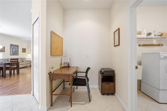 home office with washer / dryer and light wood-type flooring