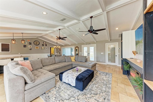 living room with ceiling fan with notable chandelier, french doors, and vaulted ceiling with beams