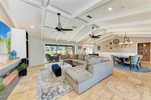 living room with lofted ceiling with beams and ceiling fan with notable chandelier