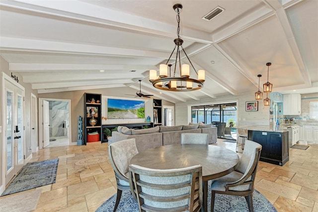 dining room featuring a healthy amount of sunlight, french doors, lofted ceiling with beams, and ceiling fan with notable chandelier