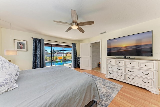 bedroom featuring light hardwood / wood-style flooring, ceiling fan, and access to outside