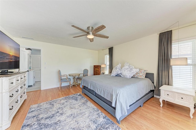 bedroom with ceiling fan and light hardwood / wood-style floors