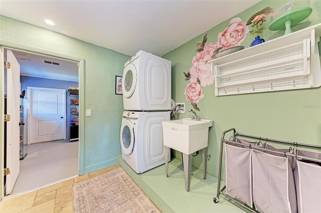 washroom featuring stacked washer / dryer