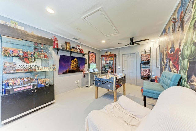 interior space with ceiling fan and ornamental molding