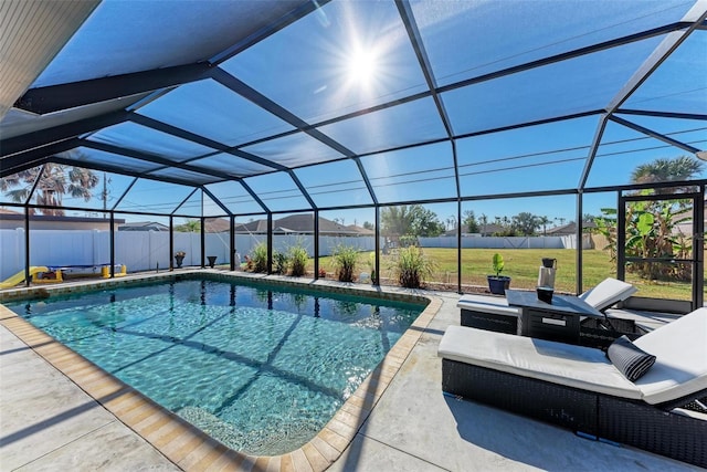 view of pool with a yard, a patio, and a lanai