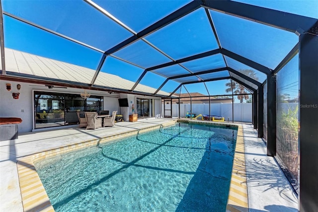 view of swimming pool with a patio area and a lanai