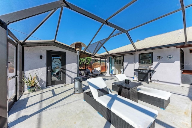 view of patio with grilling area, a lanai, and an outdoor hangout area