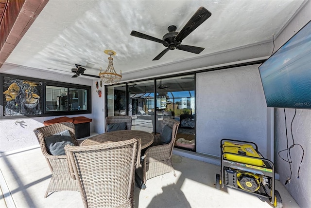 sunroom featuring ceiling fan